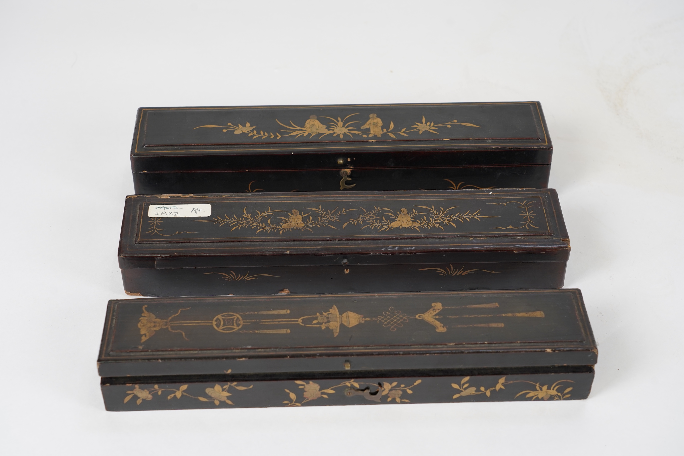 Three Chinese gilt-decorated black lacquer and painted leaf fans, 19th century